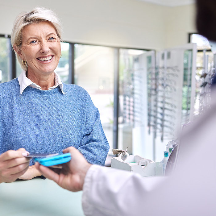 Happy woman paying using her credit card